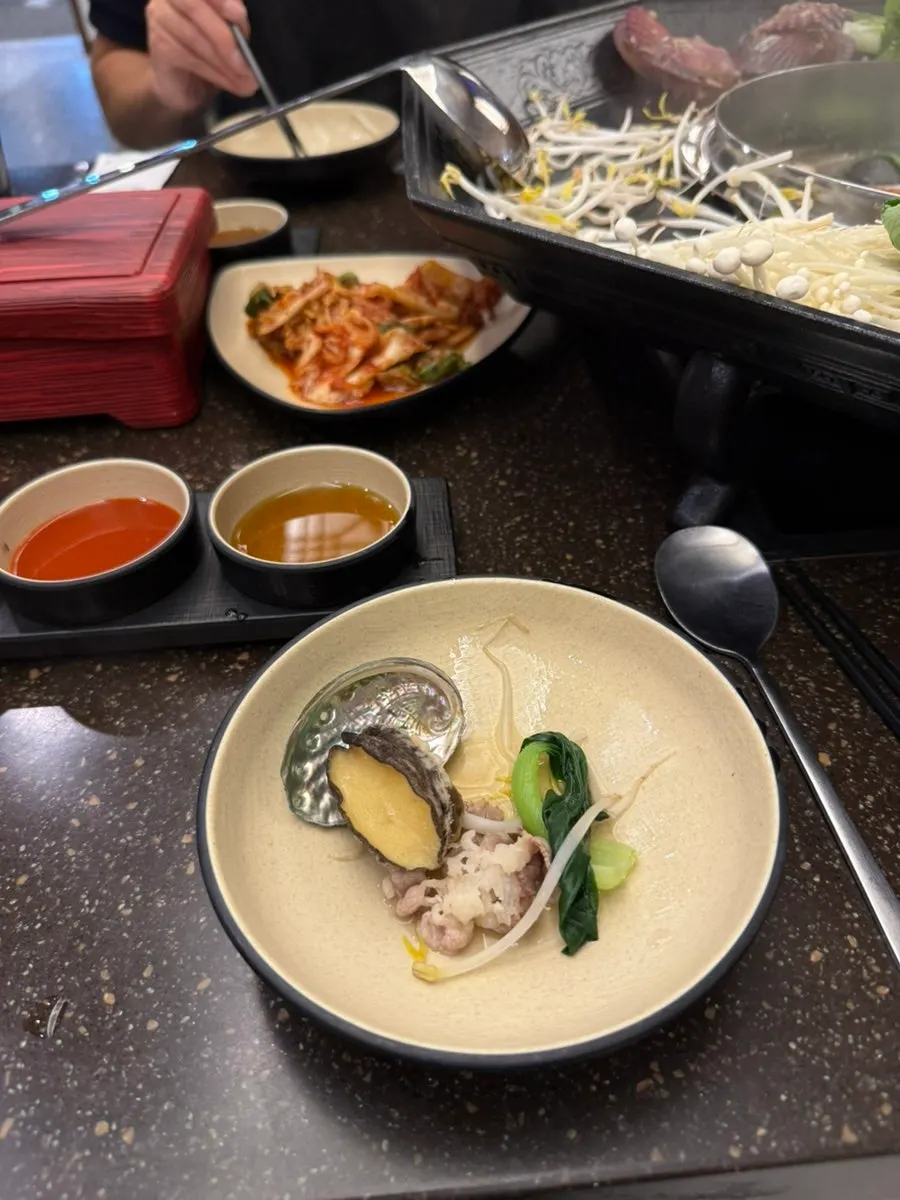 A piece of clam dipped in sauce