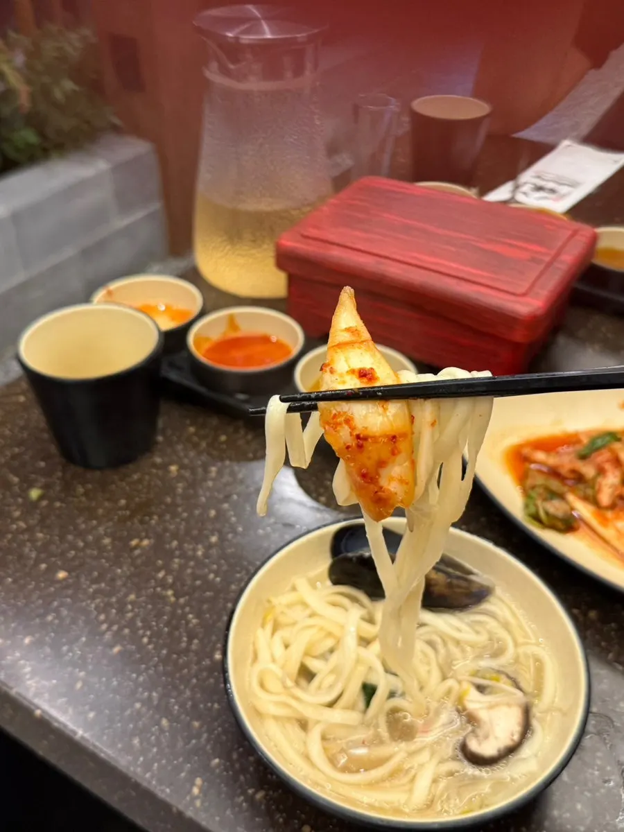 Kimchi served alongside the kalguksu