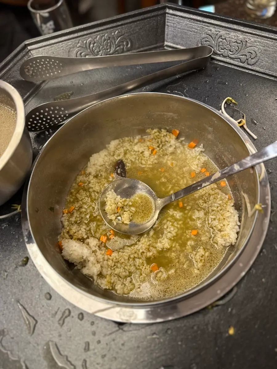 Abalone geou porridge being made in the leftover broth