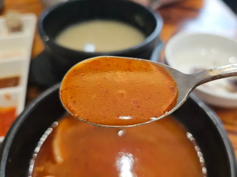 A spoonful of sundae-guk with rice dipped in