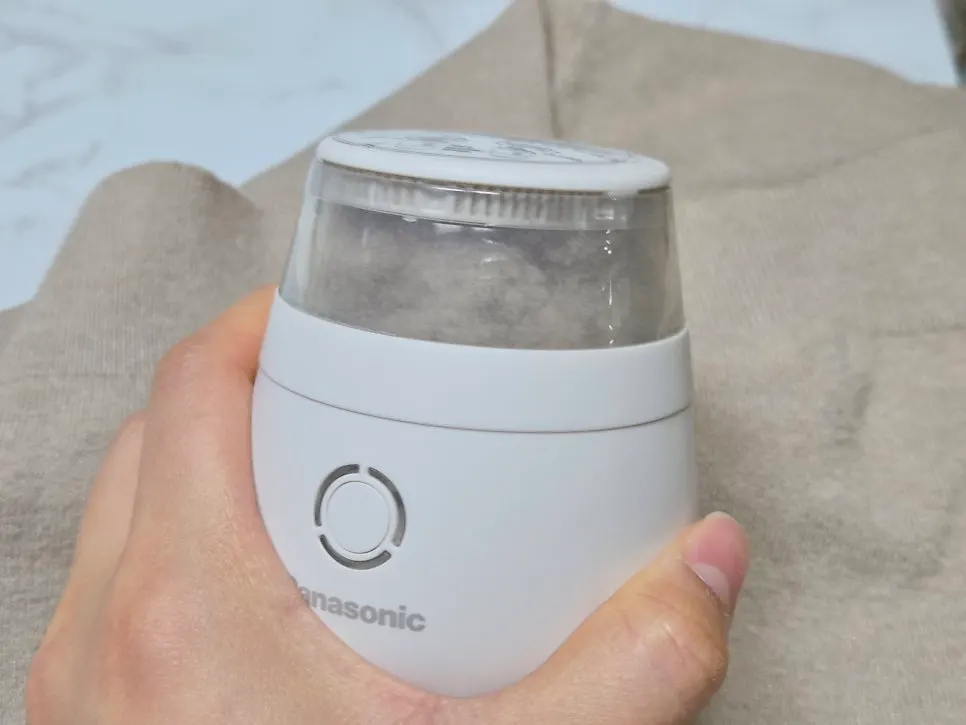 White Panasonic lint remover in a portable size