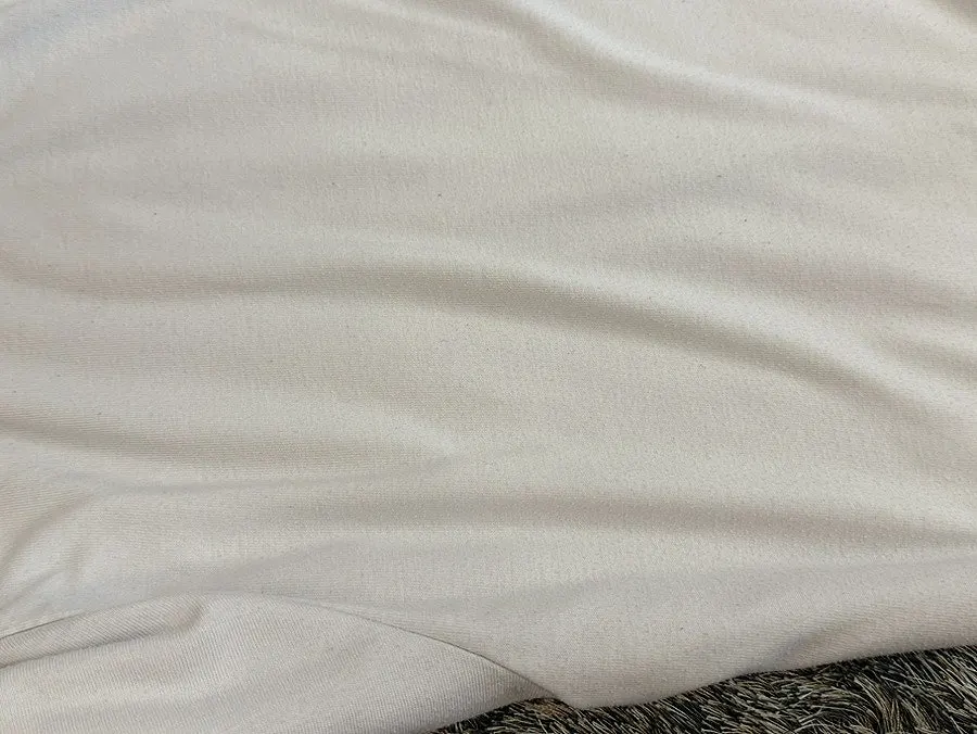 White T-shirt with mixed black and white pills before removal
