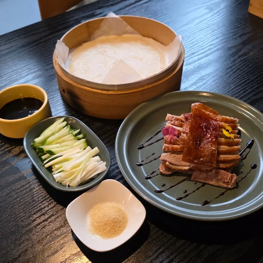 Thin pancakes and vegetables served with the half Peking duck