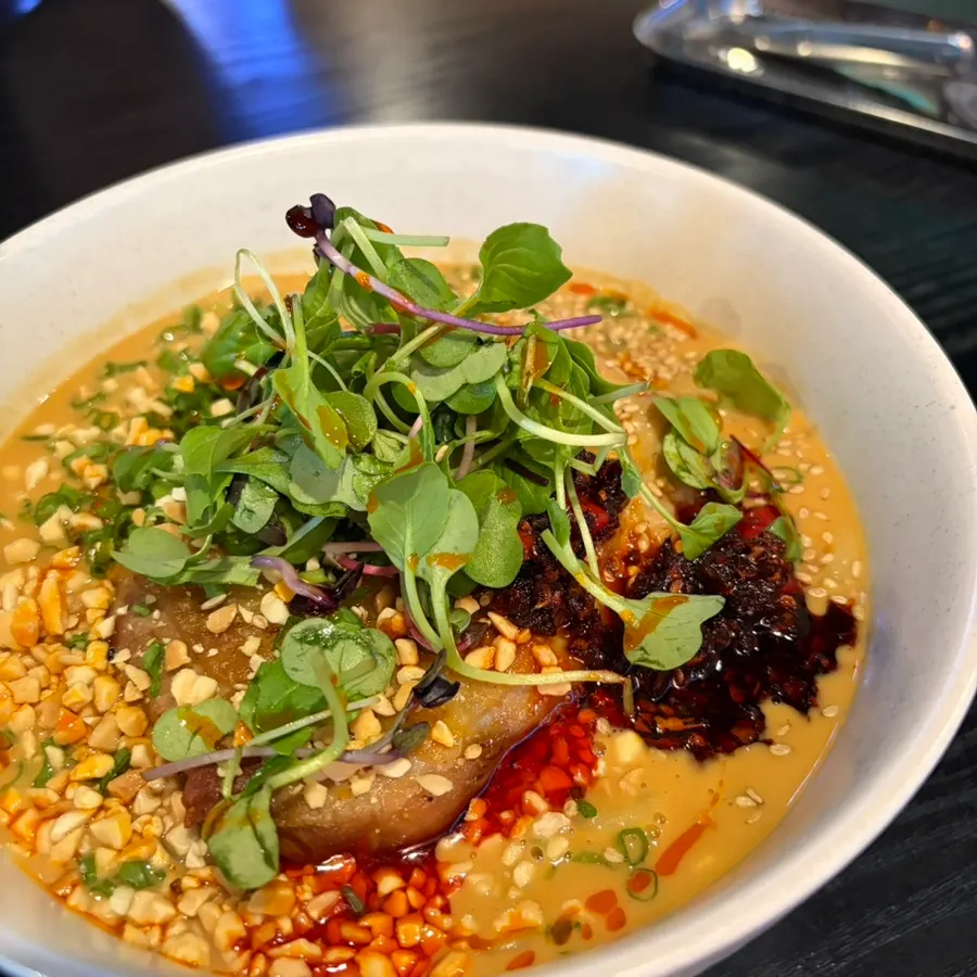 Dan dan noodles topped with peanut sauce and chicken