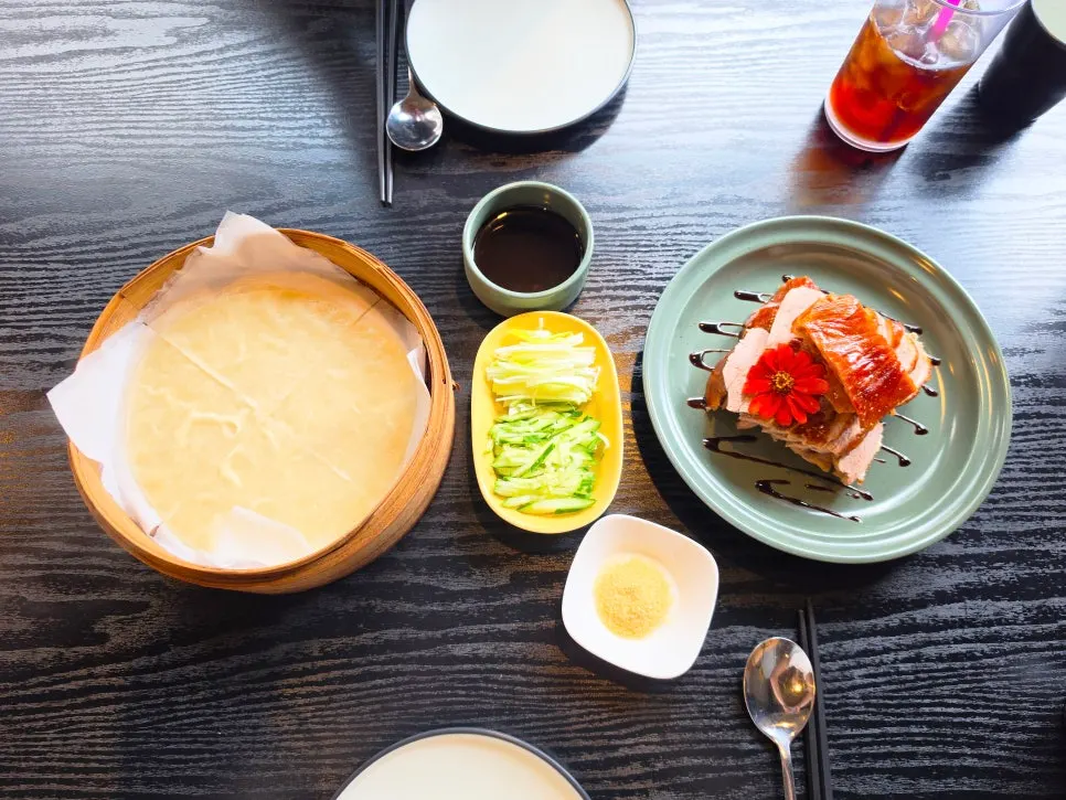 Half Peking duck served with pancakes, shredded scallion, and cucumber