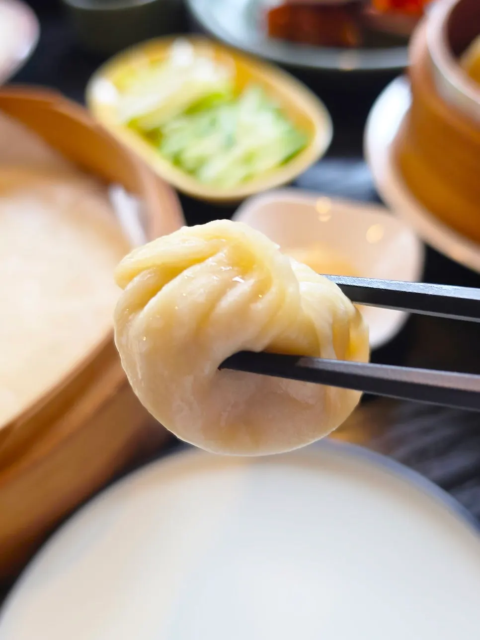 A xiaolongbao resting on a spoon