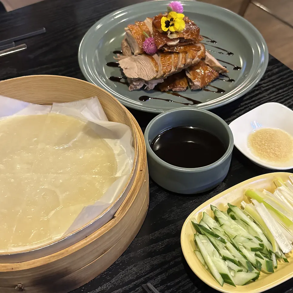 Plate of pancakes and vegetables served with Peking duck