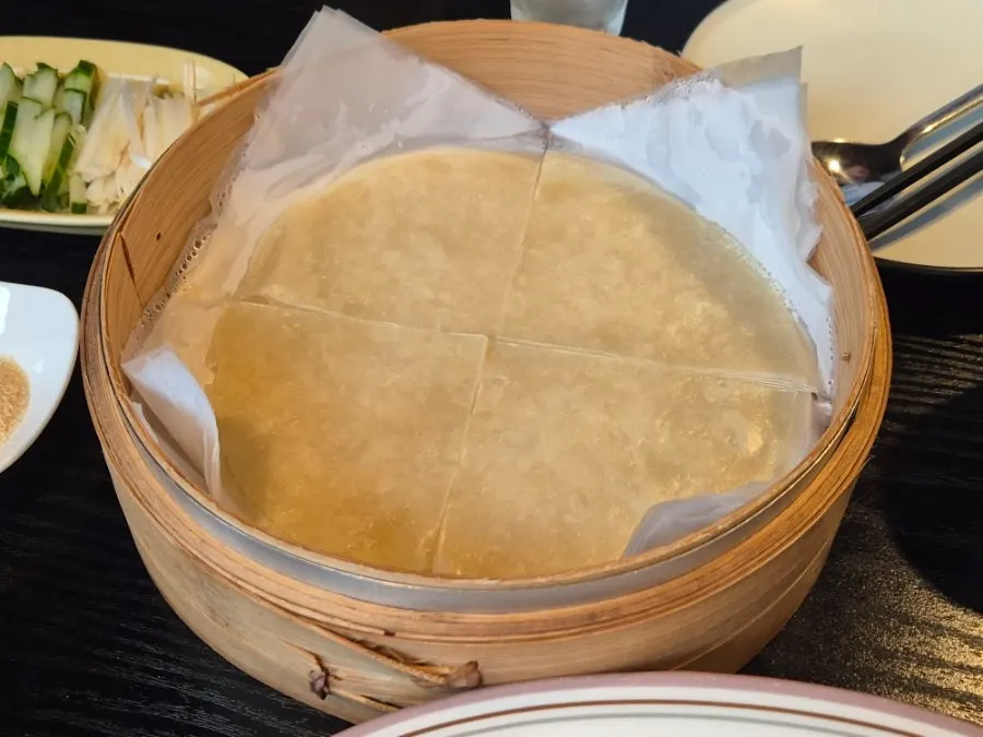 Crispy Peking duck skin dipped in sugar