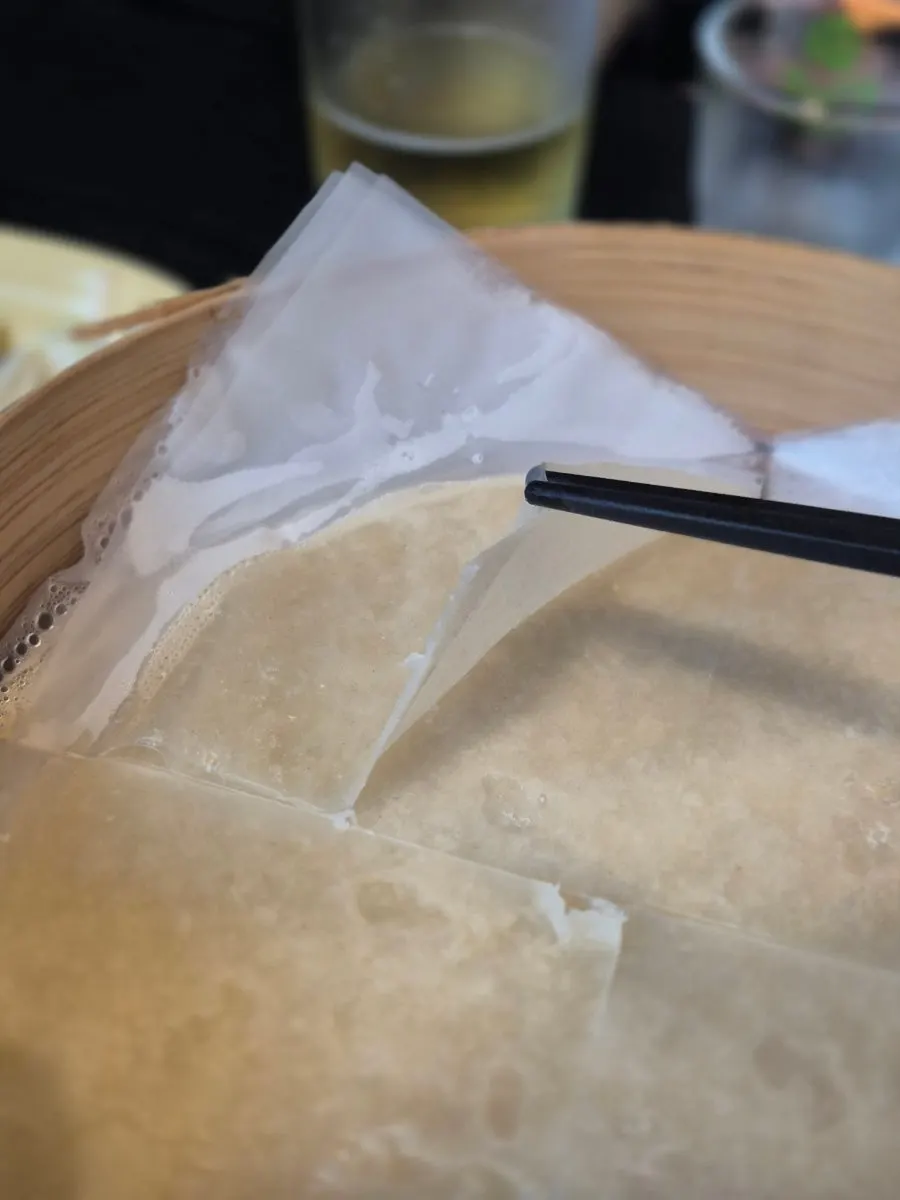 Picking up a piece of Peking duck skin