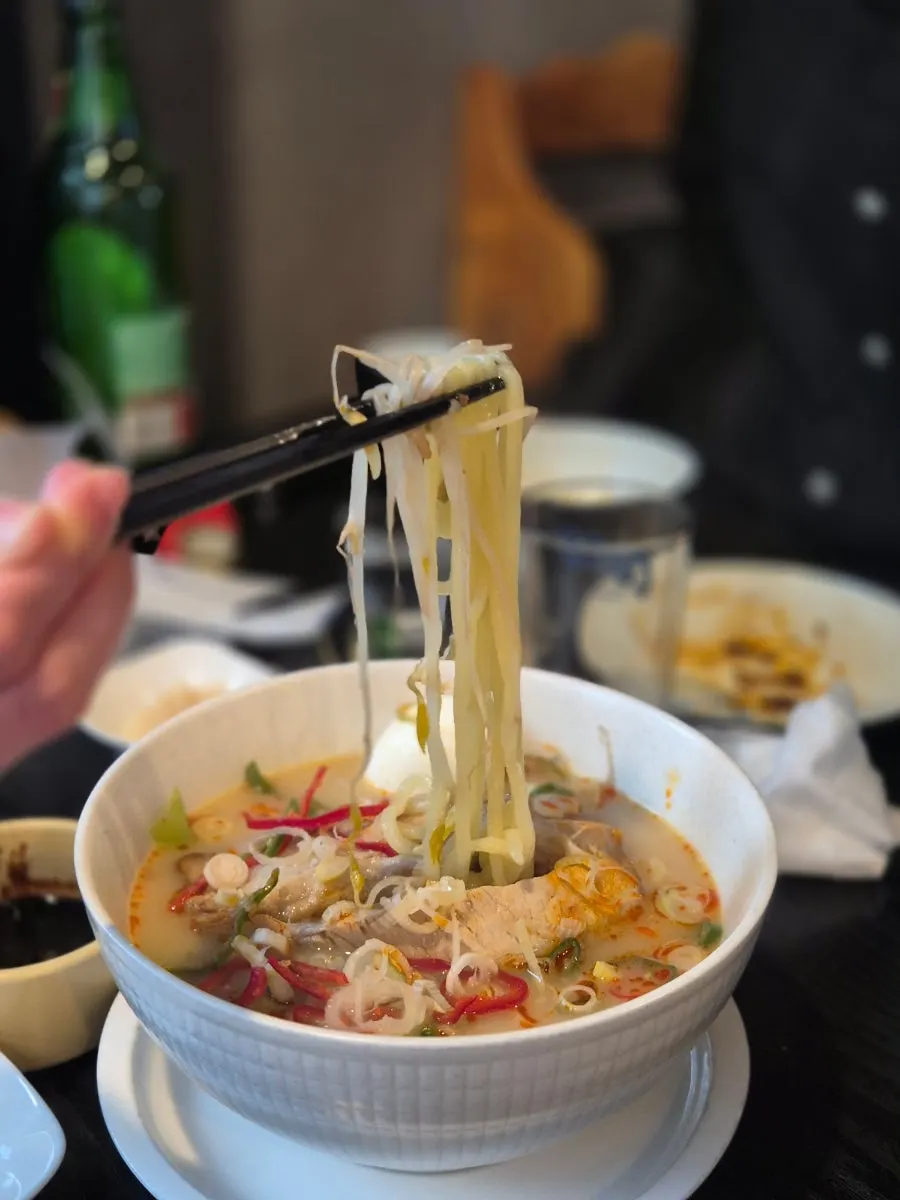 Chinese tonkotsu ramen topped with bean sprouts and egg at Panda Dim Sum