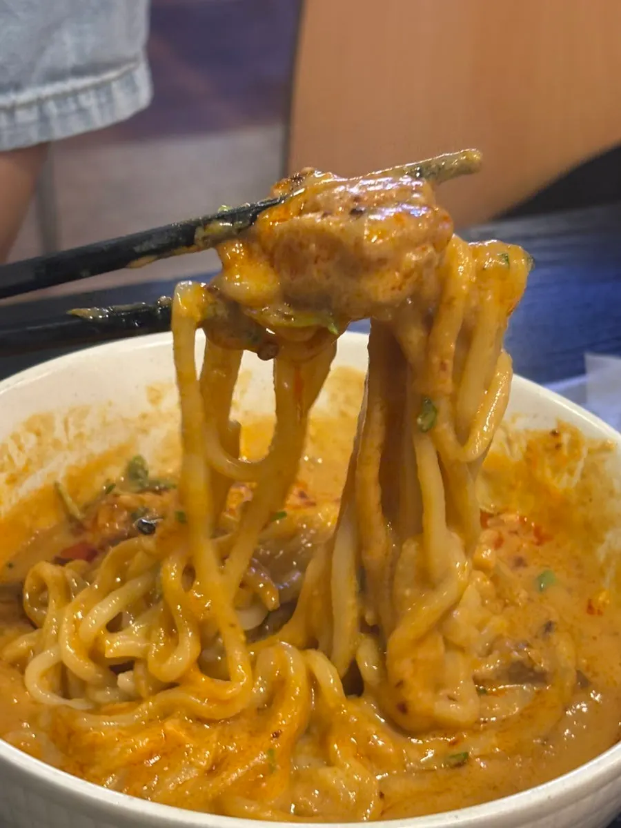 A bowl of chicken dan dan noodles