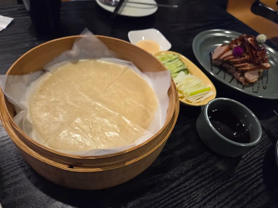 Crispy-skinned half Peking duck plated beautifully