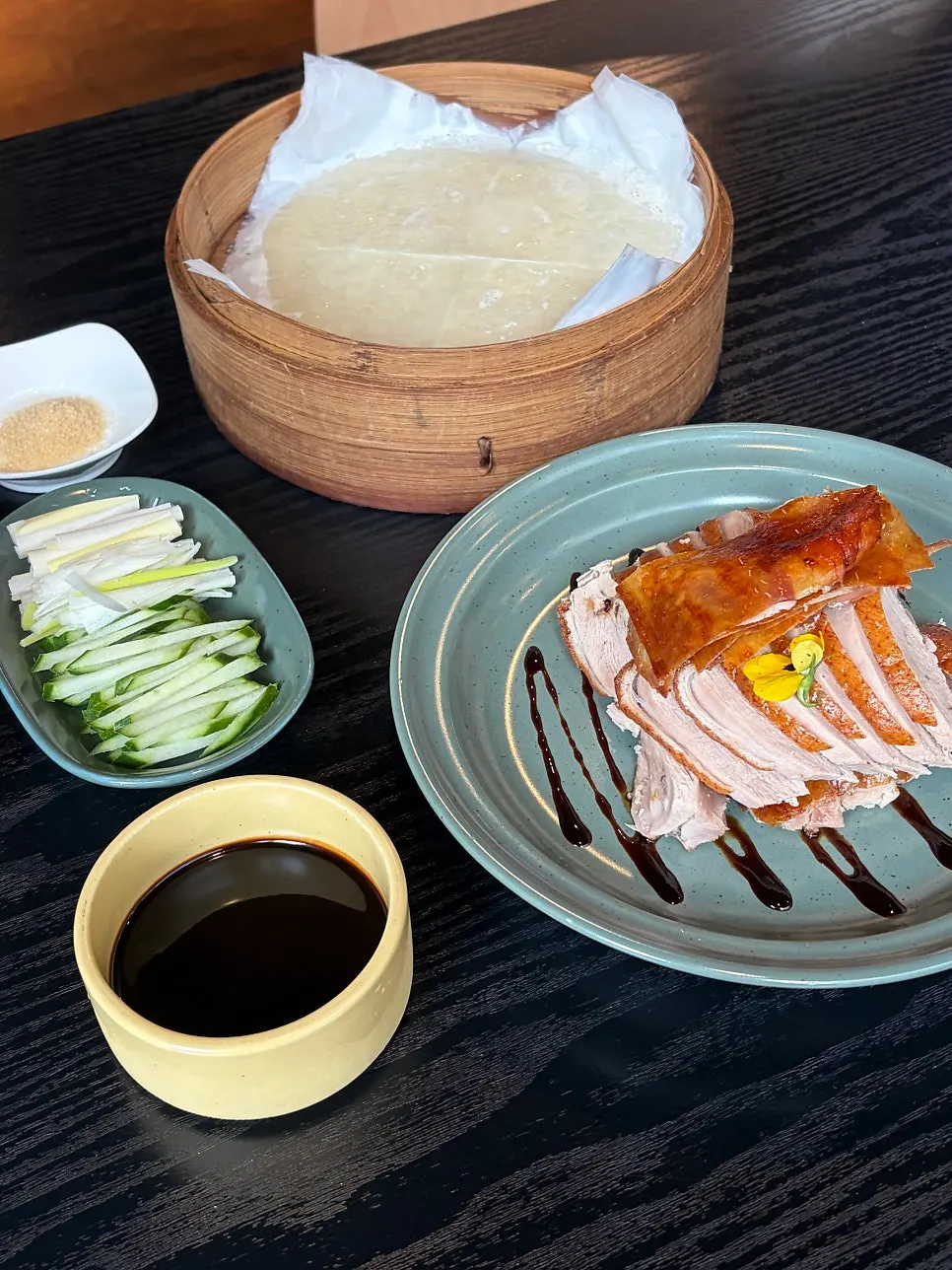 Peking duck wrapped in a pancake with scallion and cucumber