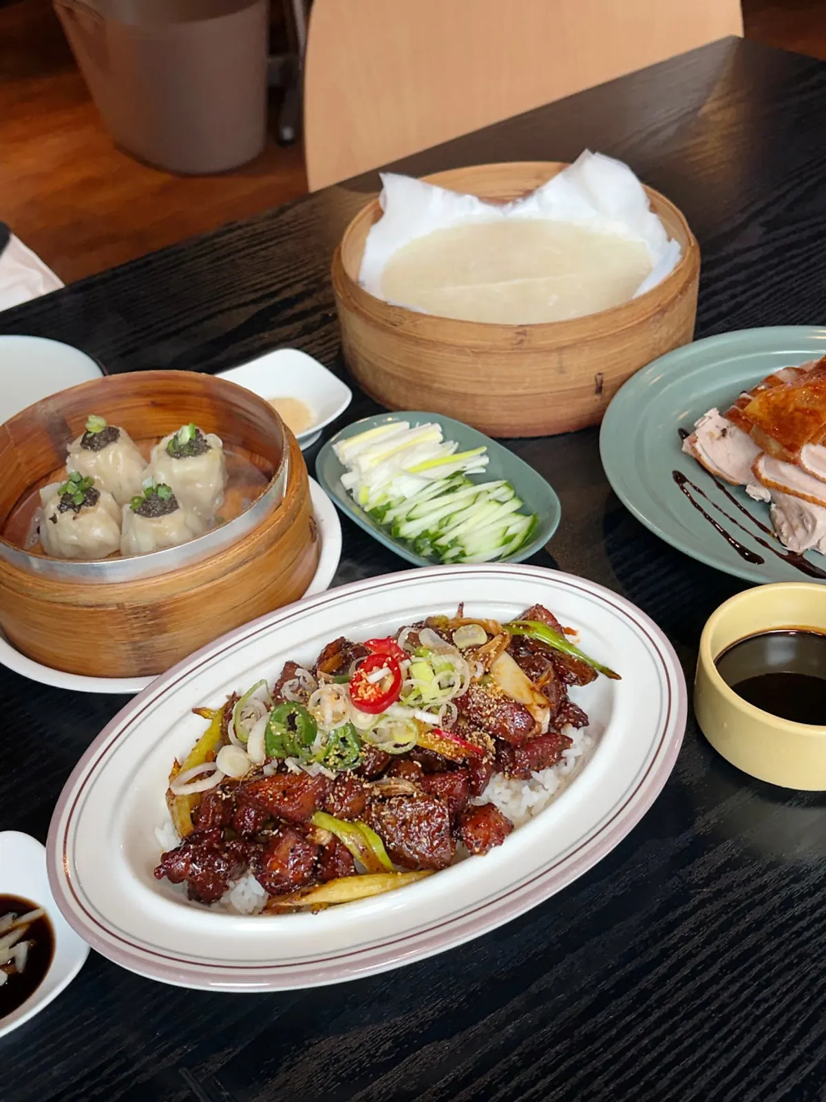 A spoonful of the rice bowl topped with beef and sautéed potato