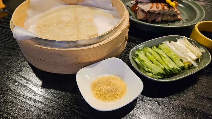Duck meat and vegetables placed on a wheat pancake