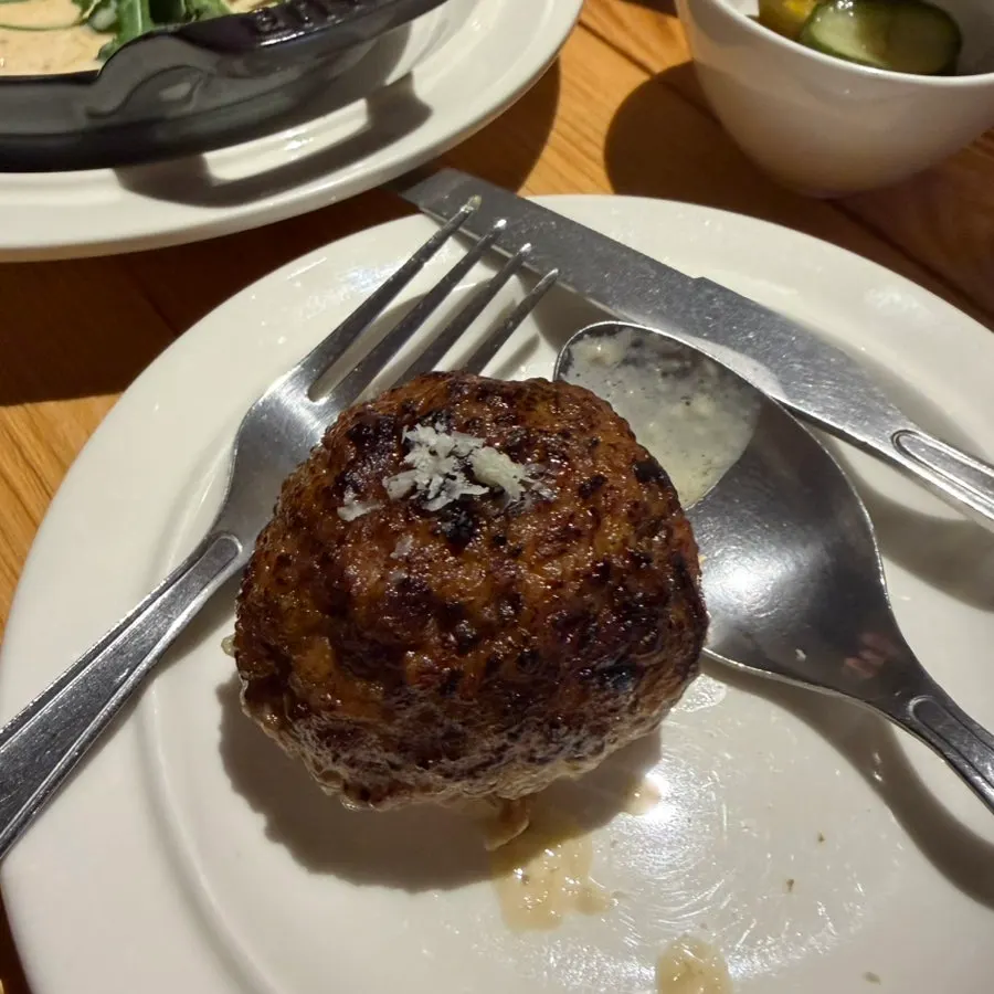 Close-up of handmade meatballs in cream sauce