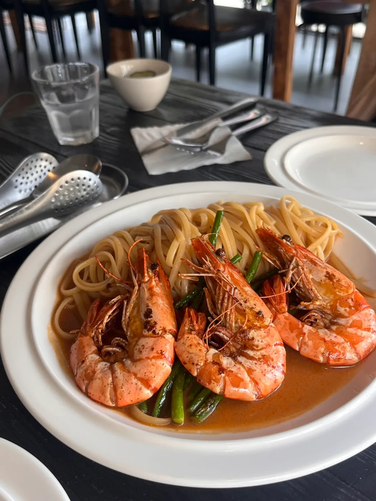 Shrimp bisque pasta topped with whole prawns