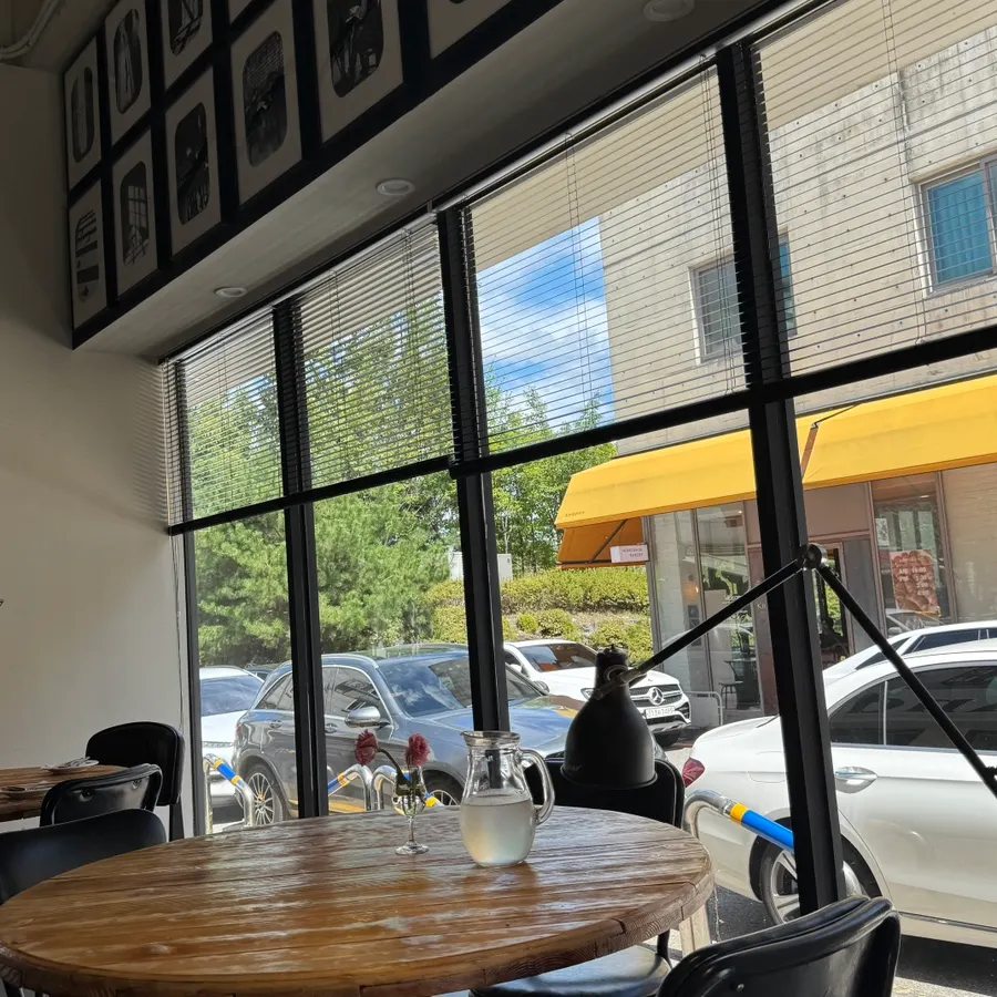 Restaurant space with a high ceiling and large windows