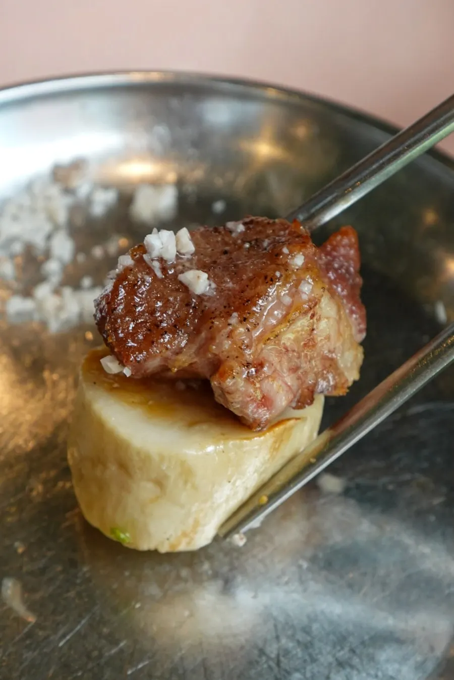 A piece of pork neck with grilled king oyster mushroom