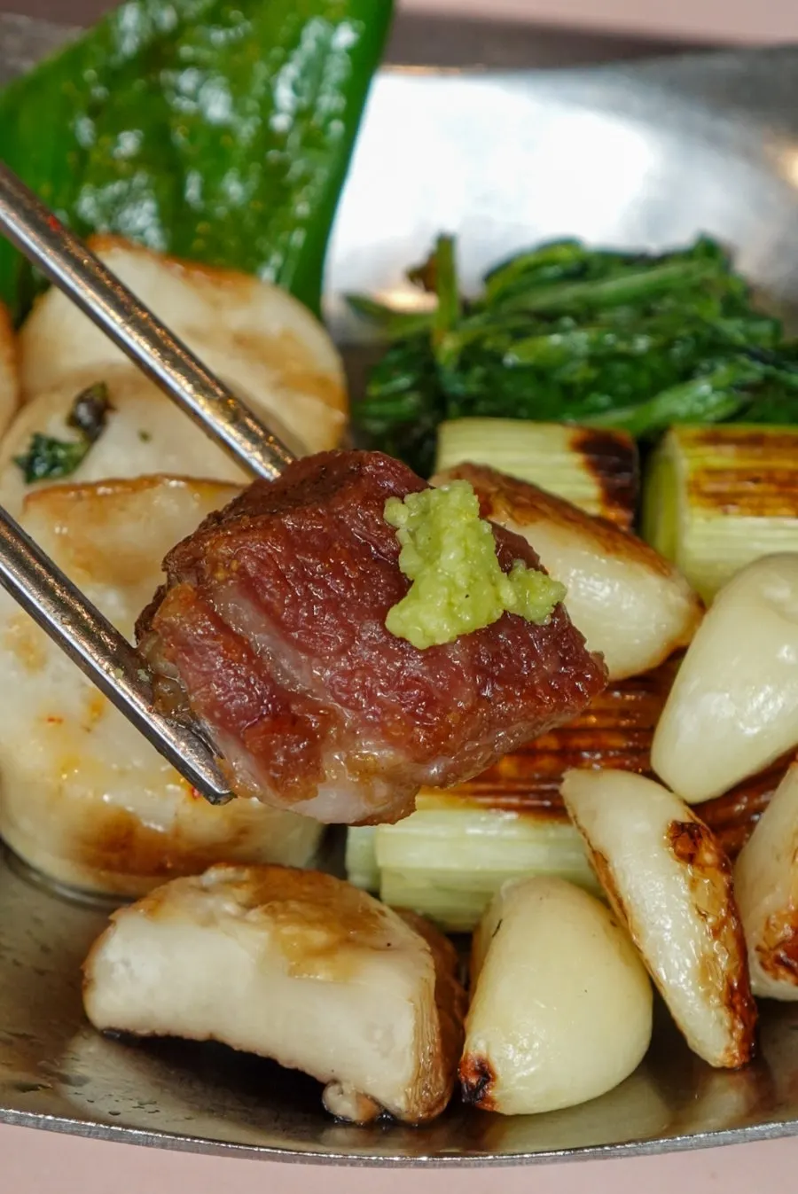 Thick pork neck topped with scallion salad