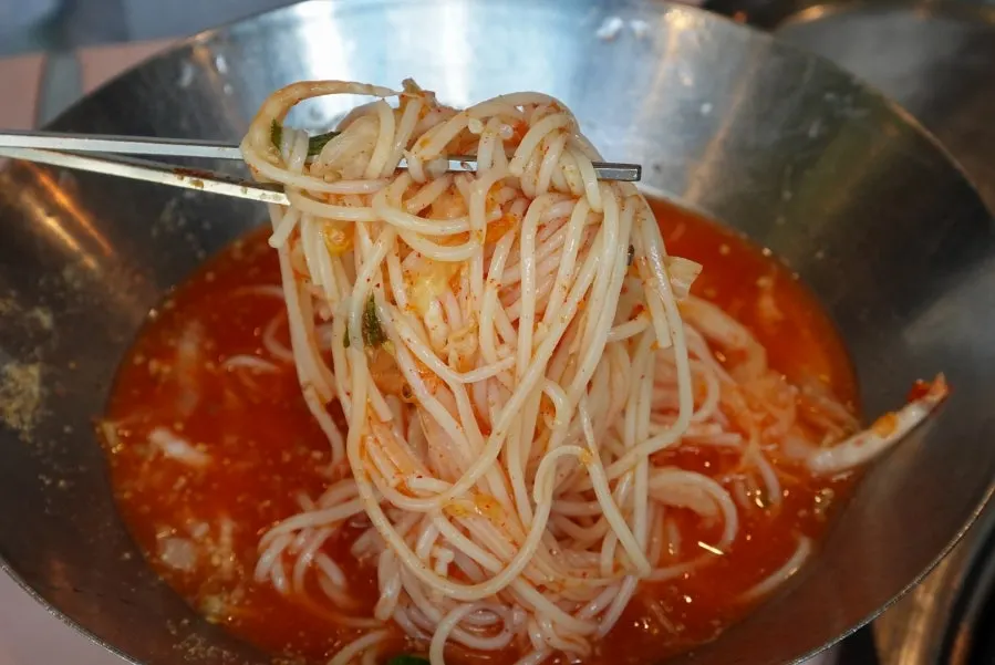 A bowl of white kimchi noodles