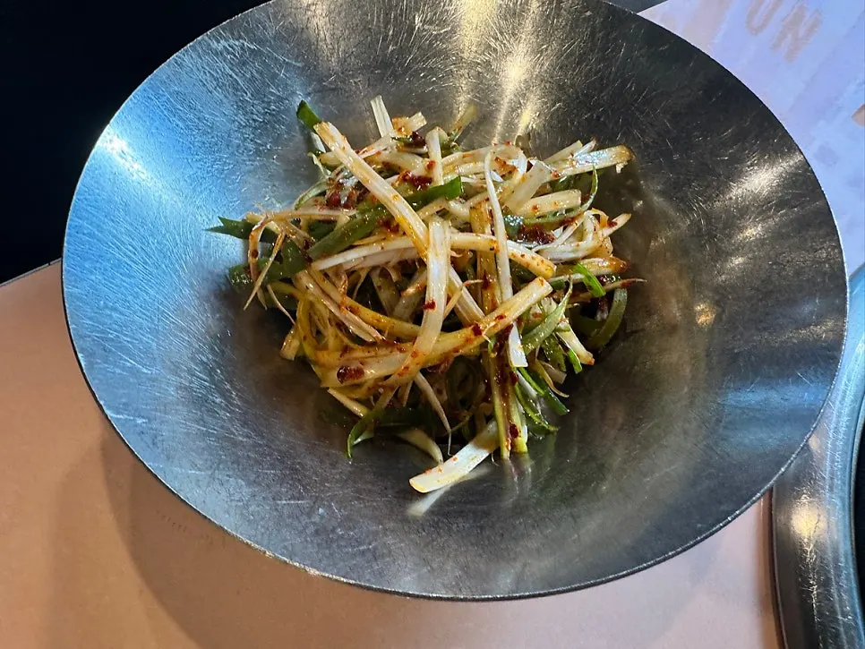 A plate of lightly seasoned scallion salad