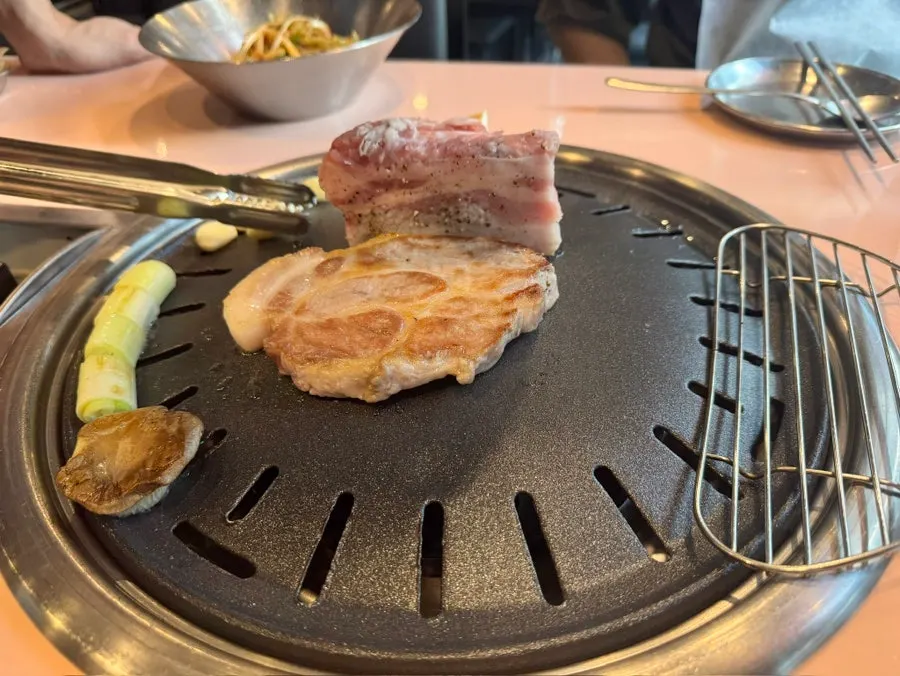Vegetables grilling alongside the meat on the grill