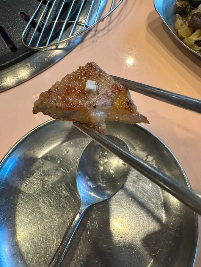 Grilled meat about to be dipped in salt