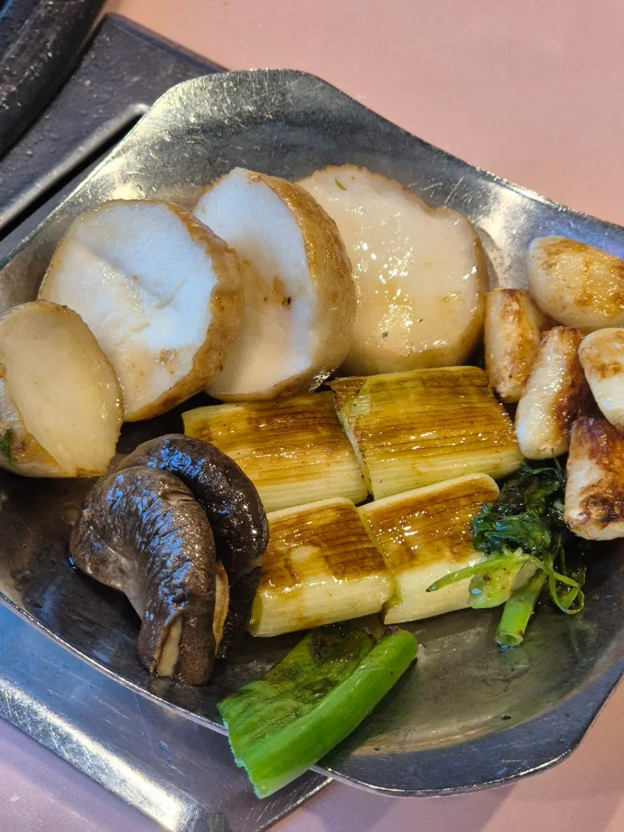 King oyster mushrooms being grilled with oil