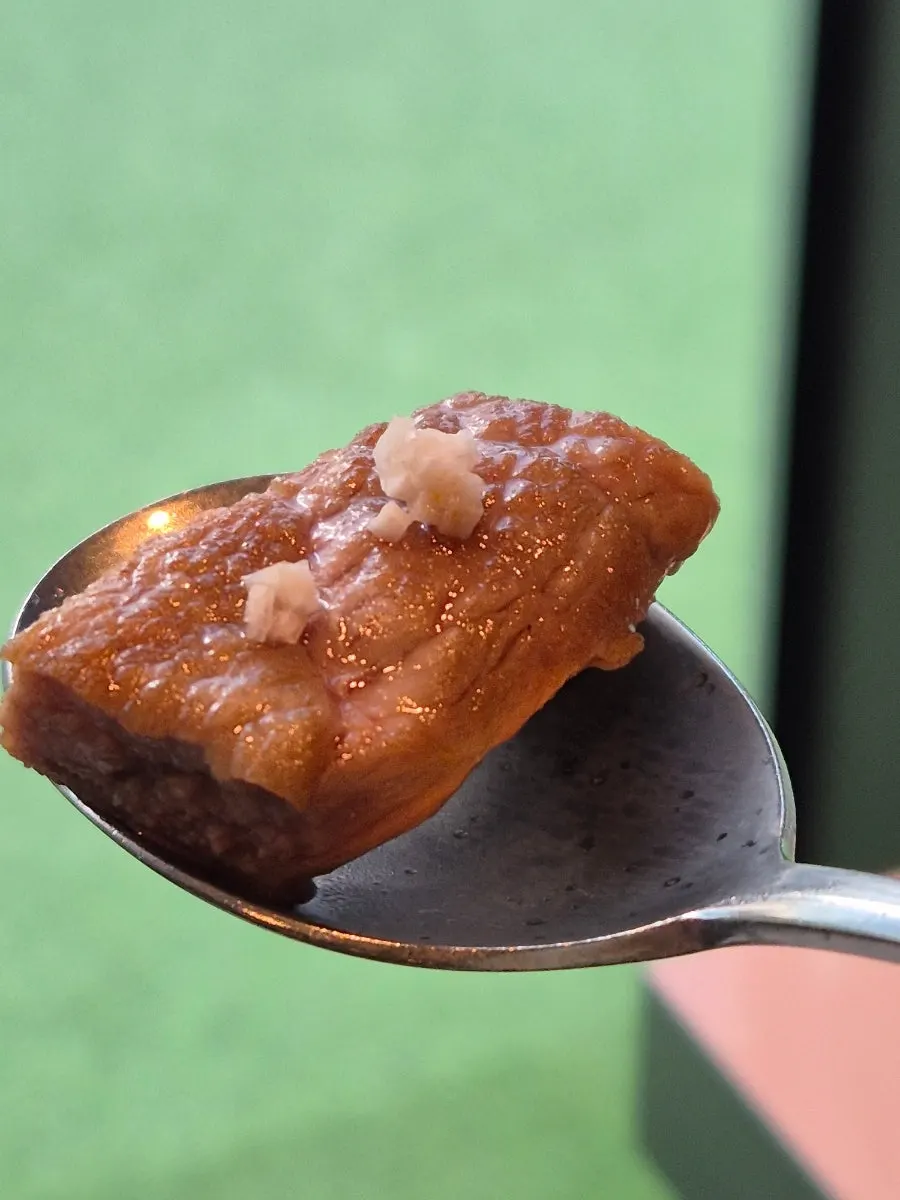 A piece of meat dipped in roasted salt