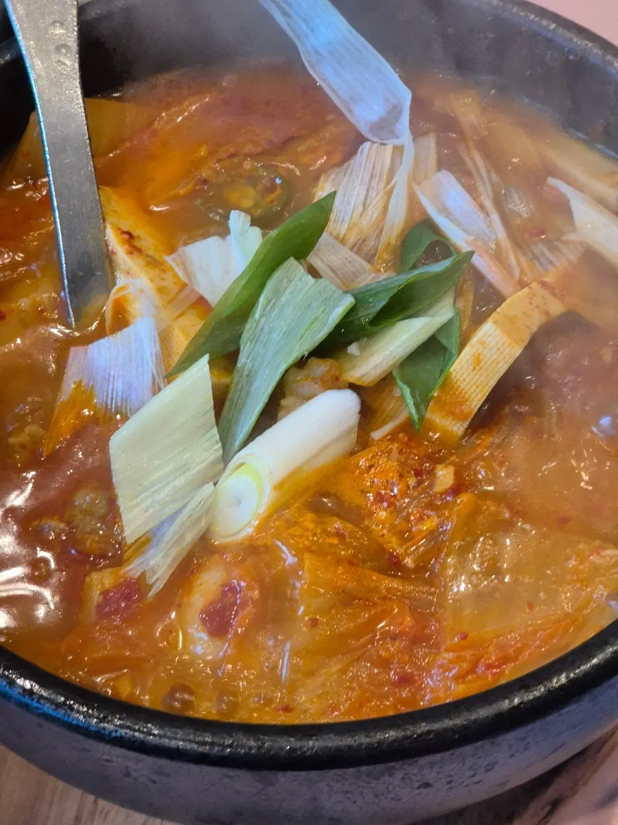 A bowl of kimchi jjigae loaded with meat