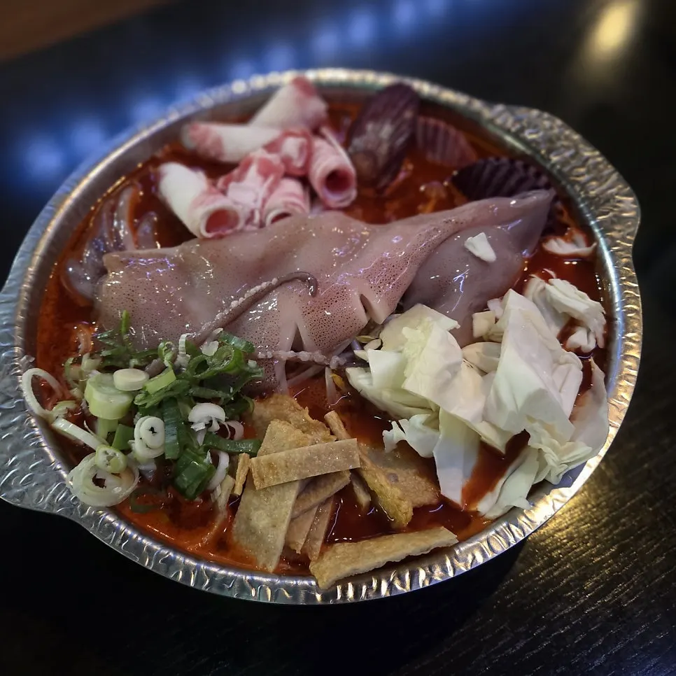Seafood tteokjjim with whole squid and beef brisket