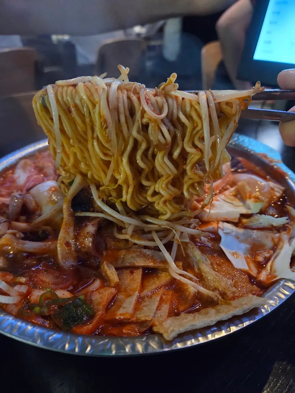 Pot of seafood tteokjjim on the table induction burner