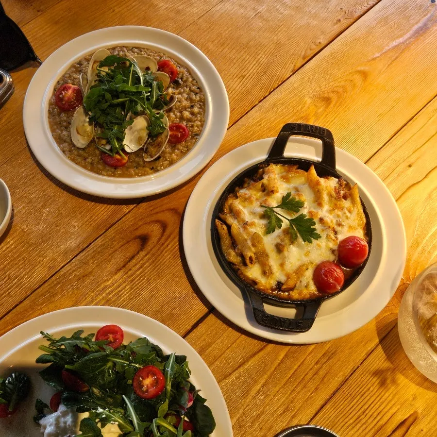 Table with salad, pasta, and risotto all together