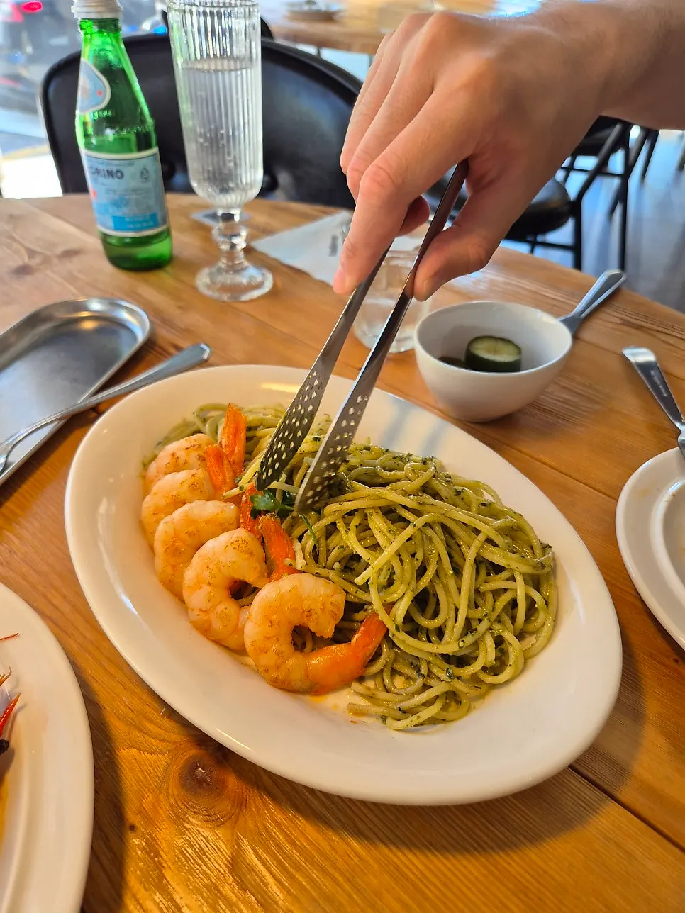 Six large shrimp on top of the basil oil pasta