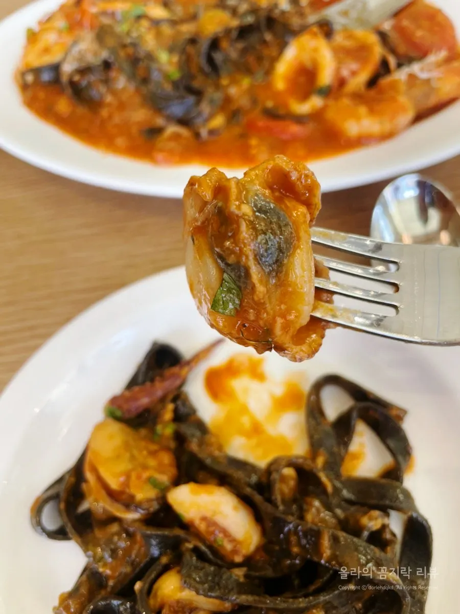 Squid ink noodles soaked in tomato sauce