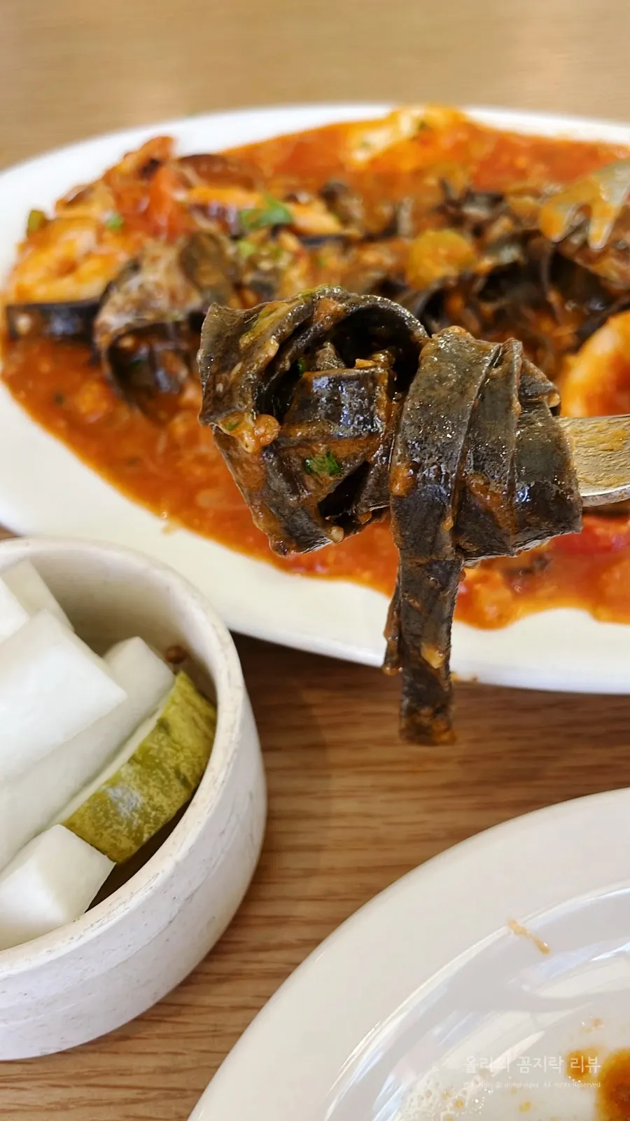 Squid ink fettuccine twirled on a fork