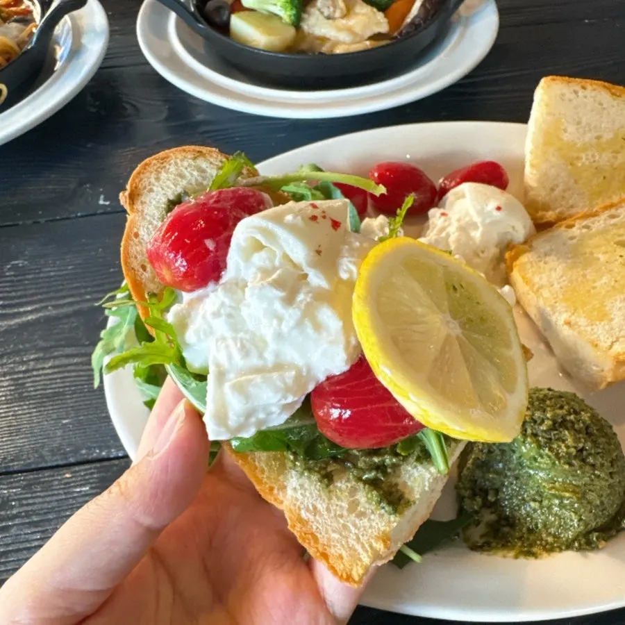 A bite of basil pesto baguette