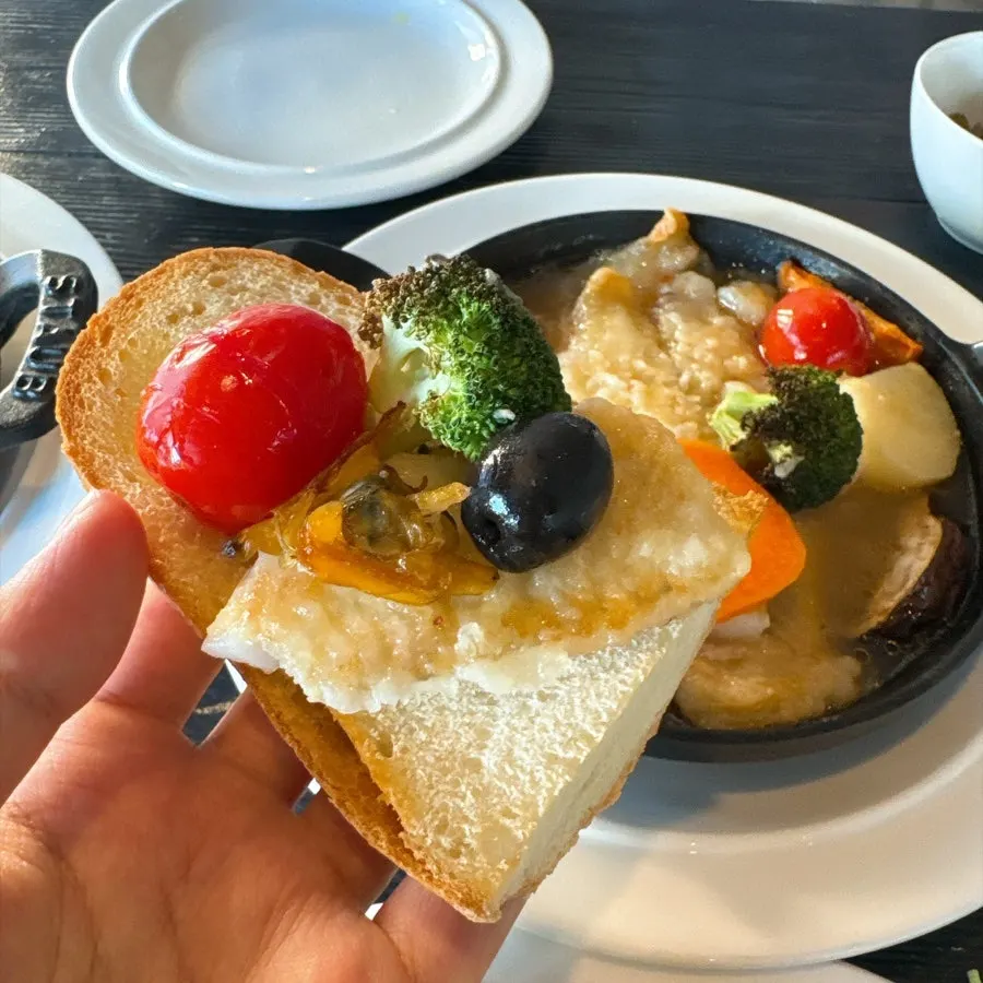 Baguette topped with flounder and vegetables
