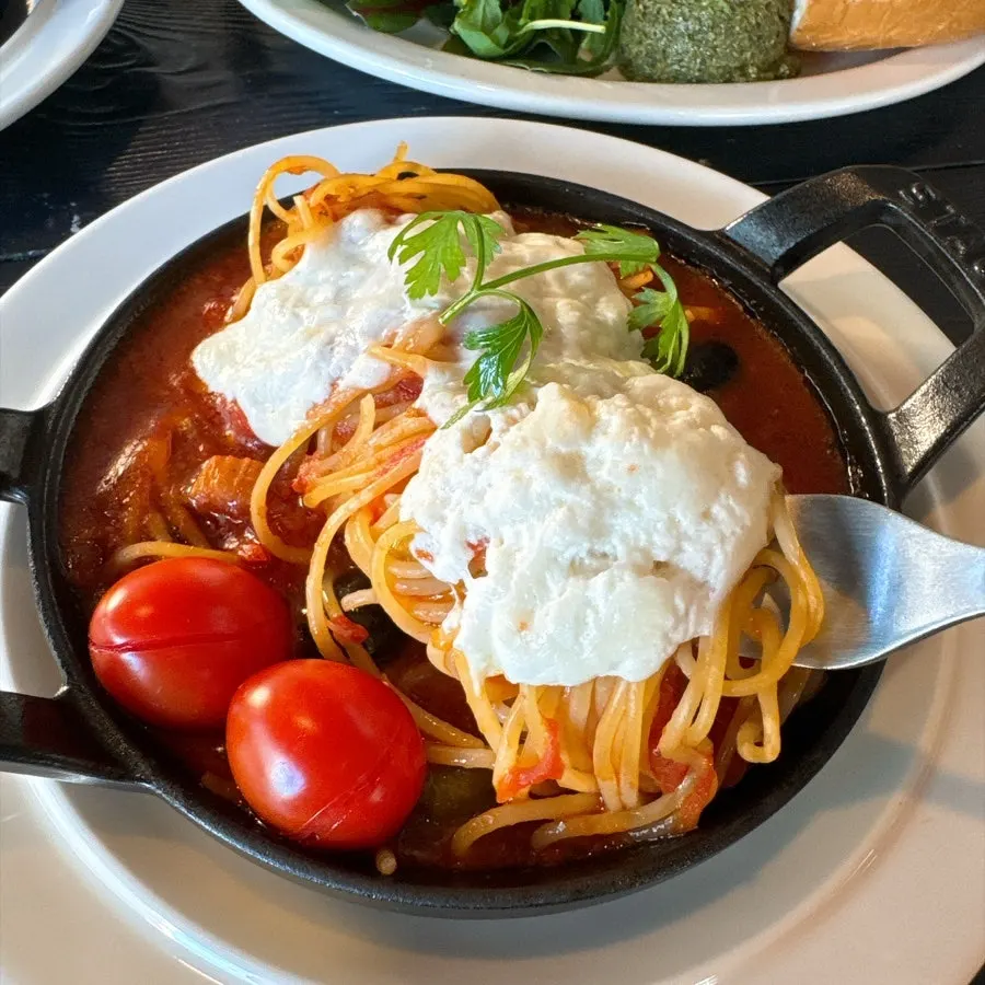 Tomato pasta topped with soft cheese