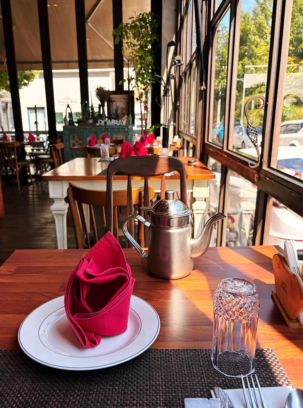Wood-tone dining space with a view of street trees