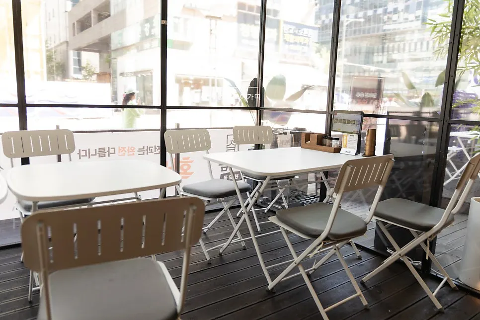Glass-enclosed outdoor terrace seating at Useum Pangyo Branch