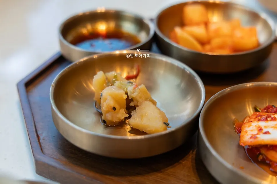Braised potatoes and dried radish strips in brass bowls