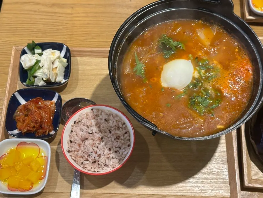 A bowl of kimchi cheese katsu nabe