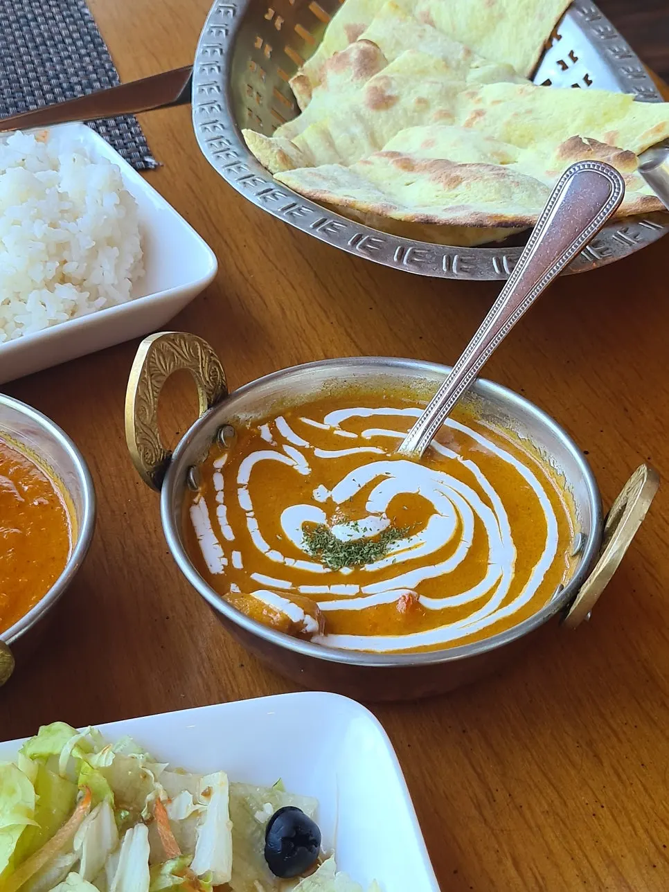 Dipping naan into curry