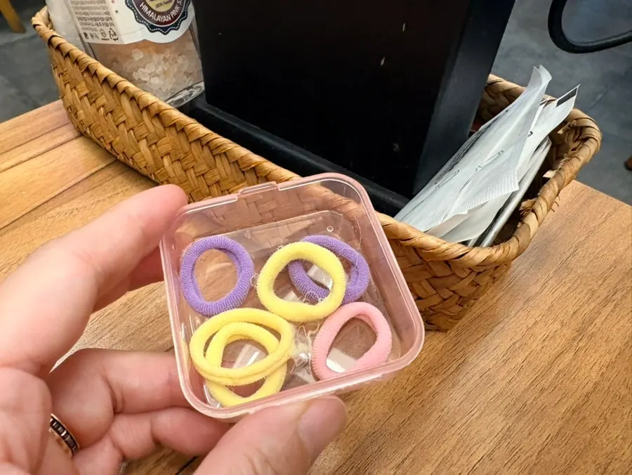 Table amenity box with hair ties and dental floss