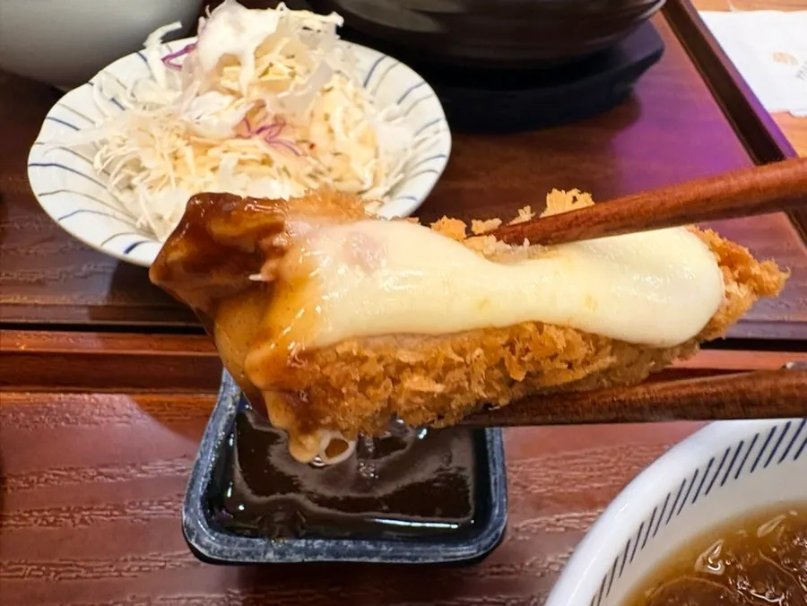 Thick tonkatsu placed over the kimchi nabe