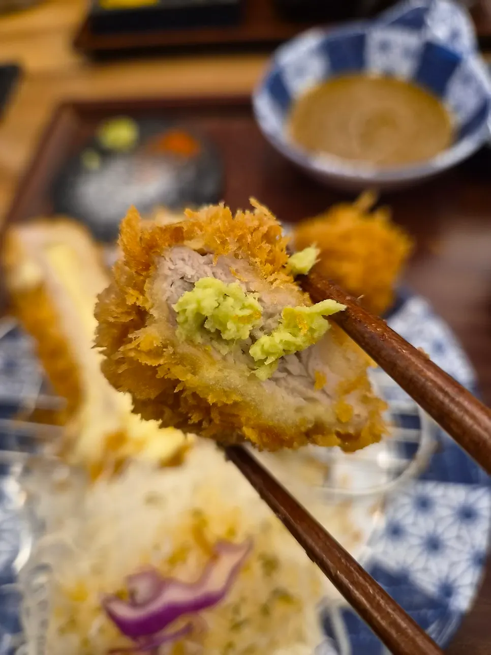 A piece of fillet katsu dipped in salt