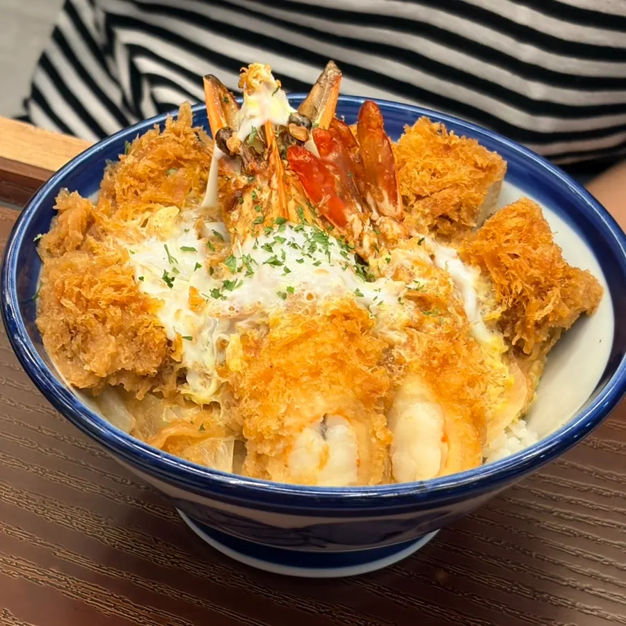 Inside view of the mixed katsu don with sauce soaked into the rice