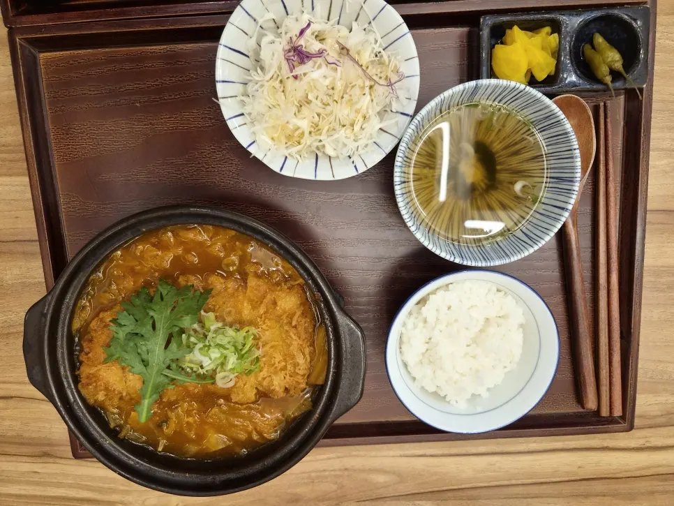 Kimchi katsu nabe bubbling in an earthenware pot